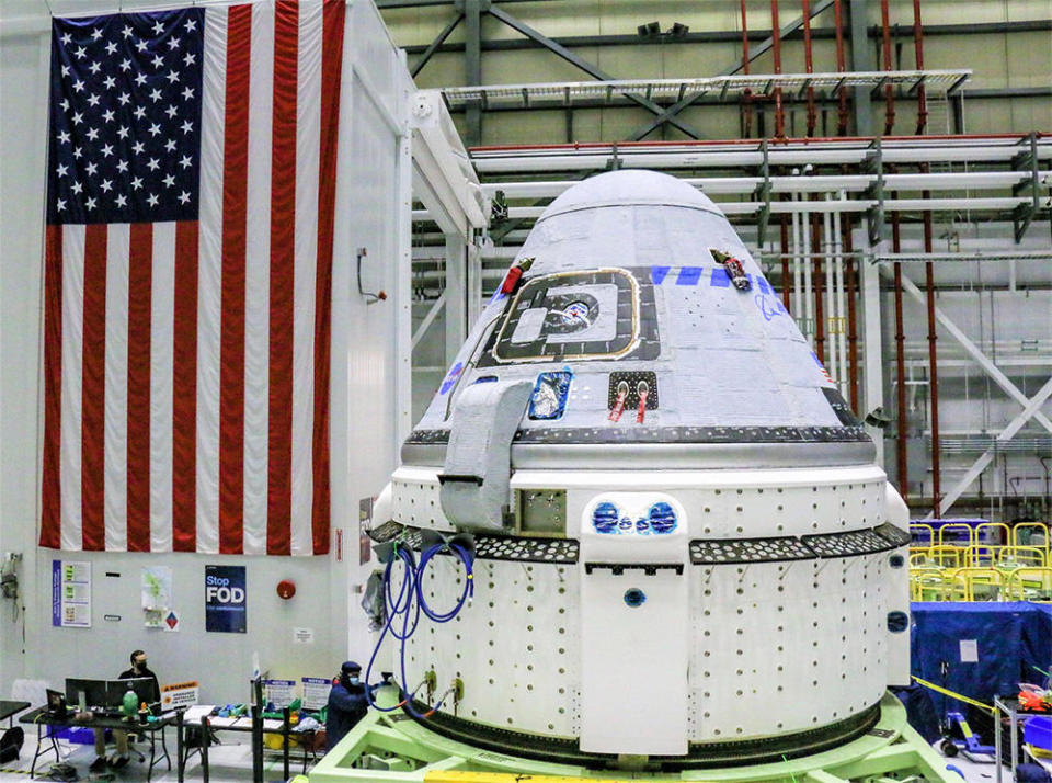 Boeing's Starliner capsule in its processing facility at the Kennedy Space Center. After resolving valve problems, the company hopes to make another attempt to launch an unpiloted test flight to the International Space Station in the first half of 2022. / Credit: Boeing