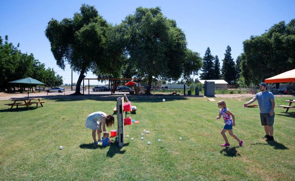 Anthony Strong and his daughter London, 9, right, play games at Old Tim Bell Farm in Waterford, Calif., Friday, June 28, 2024.