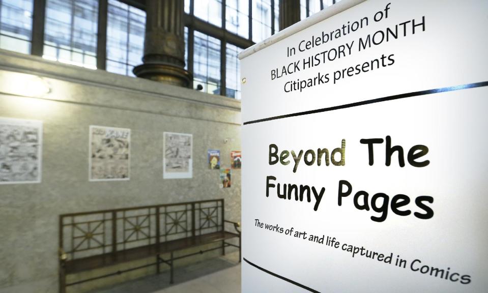 In this Wednesday, Feb. 5, 2014 photo, an exhibit at the City/County building in downtown Pittsburgh is highlighting early artists who helped break the comic book color barrier by featuring black characters and a publisher who started to break the comic color barrier in the 1930s and 1940s. (AP Photo/Keith Srakocic)