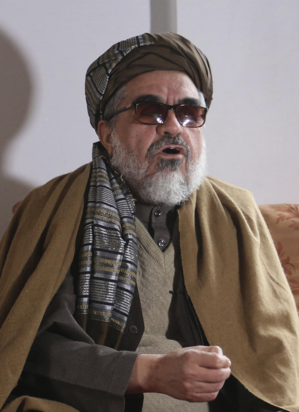 In this Friday, Nov. 22, 2019, photo, Enayatullah Baligh a member of Afghanistan scholars council, speaks during an interview to The Associated Press in Kabul, Afghanistan, (AP Photo/Tamana Sarwary)
