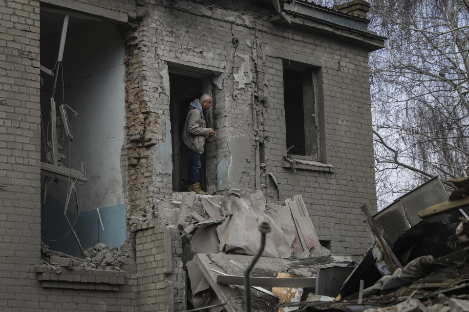 A man looks out of a damaged maternity hospital in Vilniansk, Zaporizhzhia region, Ukraine, Wednesday, Nov. 23, 2022. A Russian rocket struck the maternity wing of a hospital in eastern Ukraine on Wednesday, killing a newborn boy and critically injuring a doctor. The overnight explosion left the small-town hospital a crumbled mess of bricks, scattering medical supplies across the small compound. (AP Photo/Kateryna Klochko)