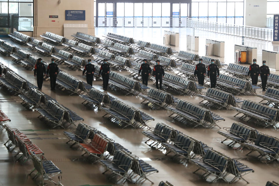 WUHAN, April 6, 2020  -- Police officers patrol Hankou Railway Station in Wuhan, central China's Hubei Province, April 6, 2020. The central Chinese city of Wuhan, once the epicenter of the novel coronavirus outbreak, will resume operation of nearly 100 passenger trains starting April 8, according to the local railway operator.     Trains have started arriving in 17 stations in Wuhan since March 28, and outbound trains will start to resume services on April 8, according to local authorities. (Photo by Hu Jinli/Xinhua via Getty) (Xinhua/Hu Jinli via Getty Images)