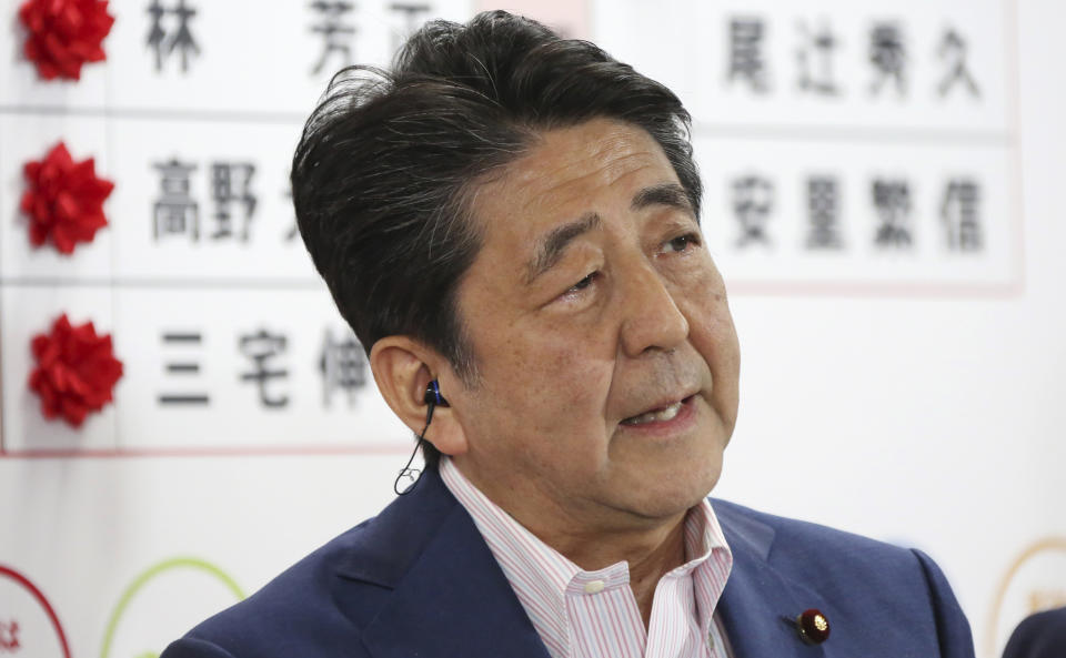 Japan's Prime Minister Shinzo Abe, leader of the Liberal Democratic Party, speaks during a TV interview about the ballot counting of the parliamentary upper house election, at their party headquarters in Tokyo, Sunday, July 21, 2019. Exit polls have showed Prime Minister Shinzo Abe's ruling coalition is certain to keep the majority of 124 seats contested in Sunday's upper house election, and could go even closer to the super-majority, the key line needed to propose a constitutional revision if joined by supporters from smaller parties. (AP Photo/Koji Sasahara)