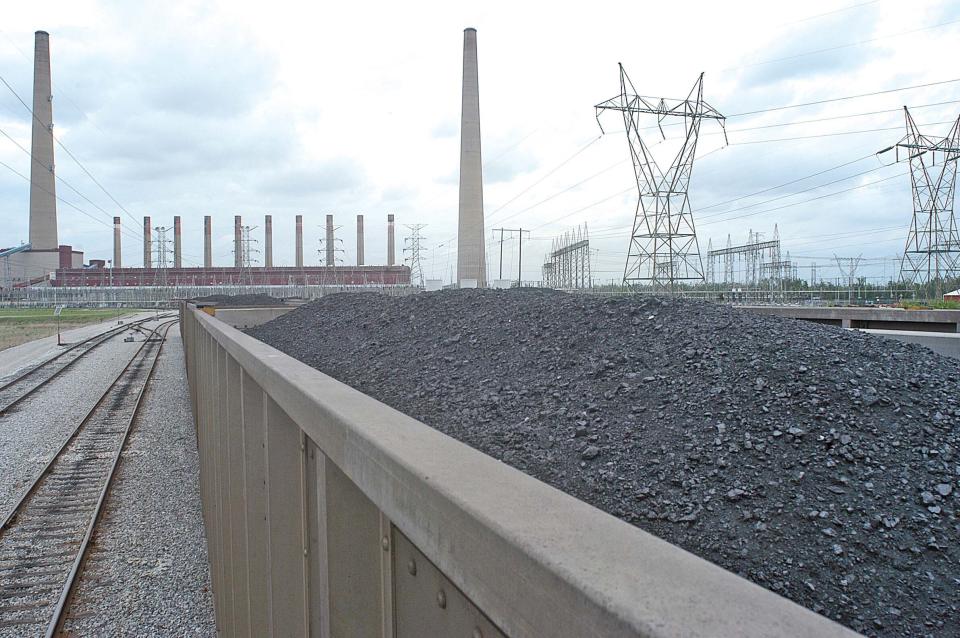 FILE - Coal is shown inside one of the train cars headed for the dumping area of the Shawnee Fossil Plant in western McCracken County, Ky. The nation's largest public utility has proposed building a $216 million solar farm project in Kentucky atop a capped coal ash storage pit at one of its coal-fired power plants. The federal Tennessee Valley Authority voted Thursday, Nov. 10, 2022 to advance the initiative at Shawnee Fossil Plant in Paducah. (John Wright/The Paducah Sun via AP)