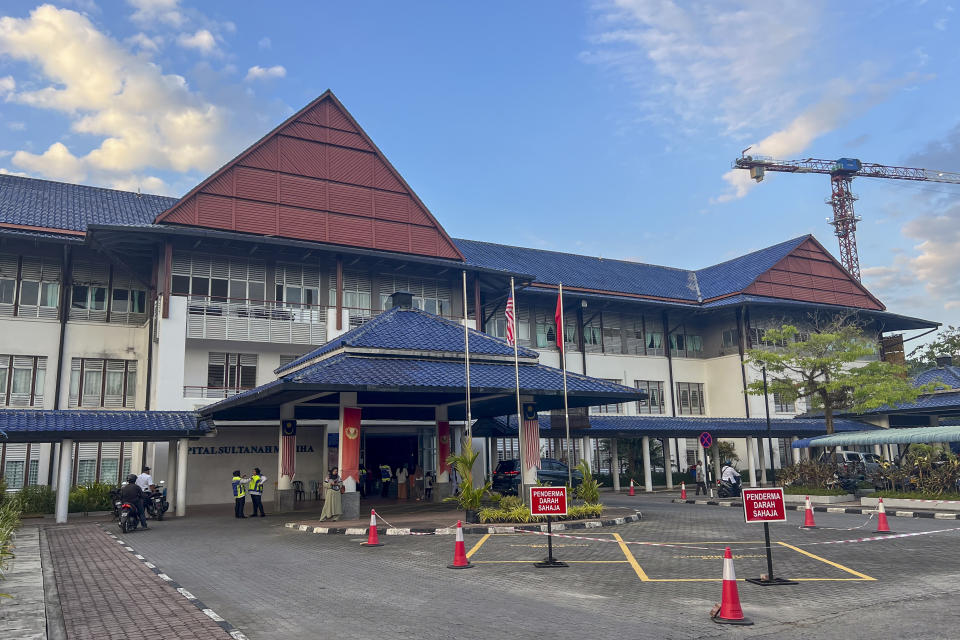 People stand outside the Sultanah Maliha Hospital, where King Harald V of Norway is believed to be admitted with an infection, on the Malaysian resort island of Langkawi, Malaysia, Wednesday, Feb. 28, 2024. Malaysian national news agency Bernama cited unidentified sources as confirming that Europe's oldest monarch was warded at the hospital’s Royal Suite. (AP Photo/Vincent Thian)