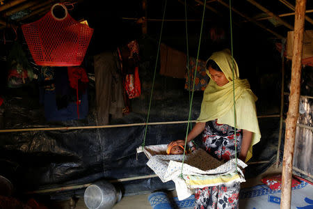 Aarafa Begum, 20, tends to her two-month-old daughter Noor Kayes, who has been suffering from fever in Kutupalang unregistered refugee camp in Cox’s Bazar, Bangladesh, February 12, 2017. REUTERS/Mohammad Ponir Hossain