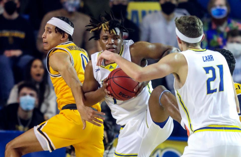 Delaware's Jyare Davis grabs a rebound in front of Drexel's Coletrane Washington and teammate Andrew Carr in the first half of Delaware's 76-68 loss at the Bob Carpenter Center, Thursday, Feb. 3, 2022.