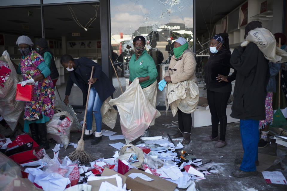 Volunteers participate in the cleaning efforts at Soweto's Diepkloof mall outside Johannesburg, South Africa, Thursday July 15, 2021. A massive cleaning effort has started following days of violence in Gauteng and KwaZulu-Natal provinces. The violence erupted last week after Zuma began serving a 15-month sentence for contempt of court for refusing to comply with a court order to testify at a state-backed inquiry investigating allegations of corruption while he was president from 2009 to 2018. (AP Photo/Jerome Delay)