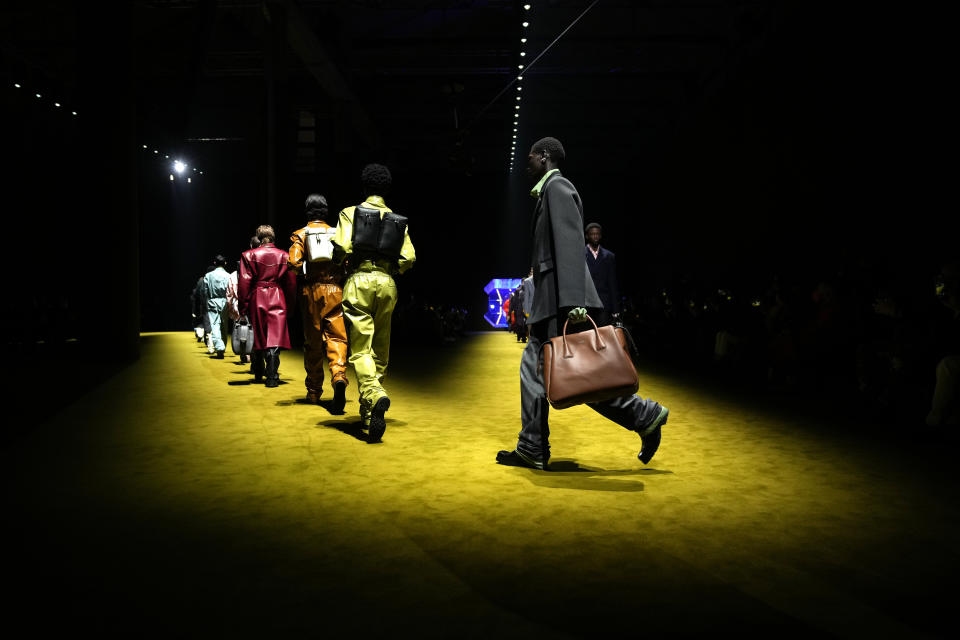 Models wear creations as part of the Prada men's Fall-Winter 2022-23 collection, unveiled during the Fashion Week in Milan, Italy, Sunday, Jan. 16, 2022. (AP Photo/Luca Bruno)