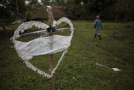 A heart-shaped sign displays the name of Jakelin Amei Rosmey Caal in Raxruha, Guatemala, on Saturday, Dec. 15, 2018. The 7-year-old girl died in a Texas hospital, two days after being taken into custody by border patrol agents in a remote stretch of New Mexico desert. (AP Photo/Oliver de Ros)