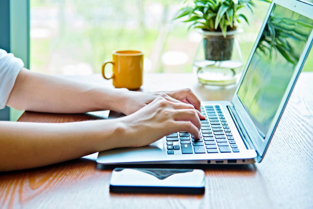 female hands typing on laptop