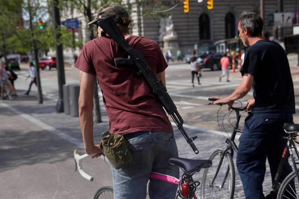 Armed bike rider at public square 