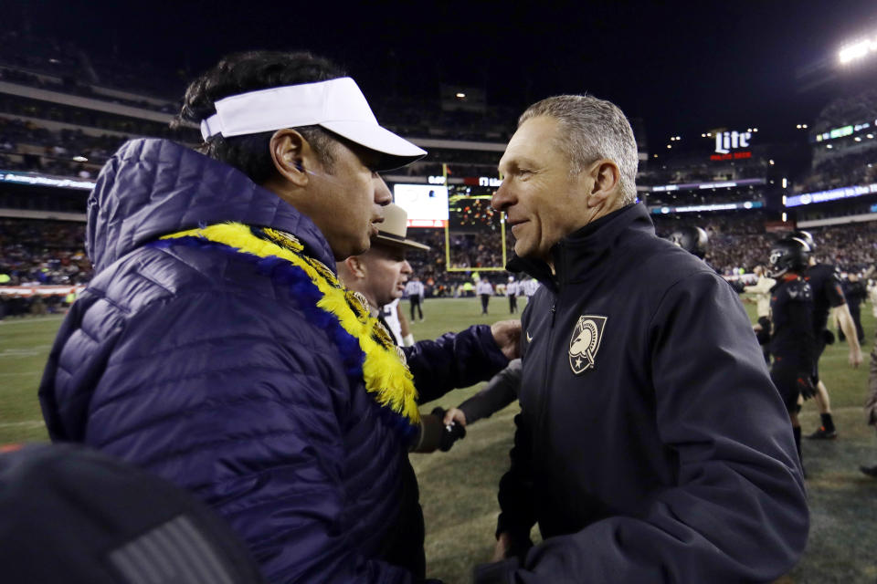 FIEL - In this Dec. 8, 2018, file photo, Army head coach Jeff Monken, right, greets Navy head coach Ken Niumatalolo after an NCAA college football game in Philadelphia. The 120th Army-Navy game is set for Saturday in Philadelphia. Army is trying to win its fourth straight game in the series. (AP Photo/Matt Slocum, File)