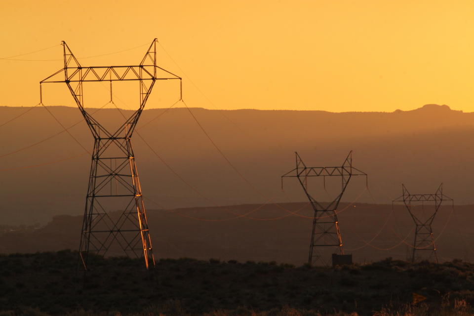 This Aug. 20, 2019, image shows transmission lines leading from the Navajo Generating Station near Page, Ariz. The power plant will close before the year ends. Other coal-fired plants in the region and in the U.S. are on track to shut down or reduce output as utilities turn to natural gas and renewable energy. (AP Photo/Susan Montoya Bryan)