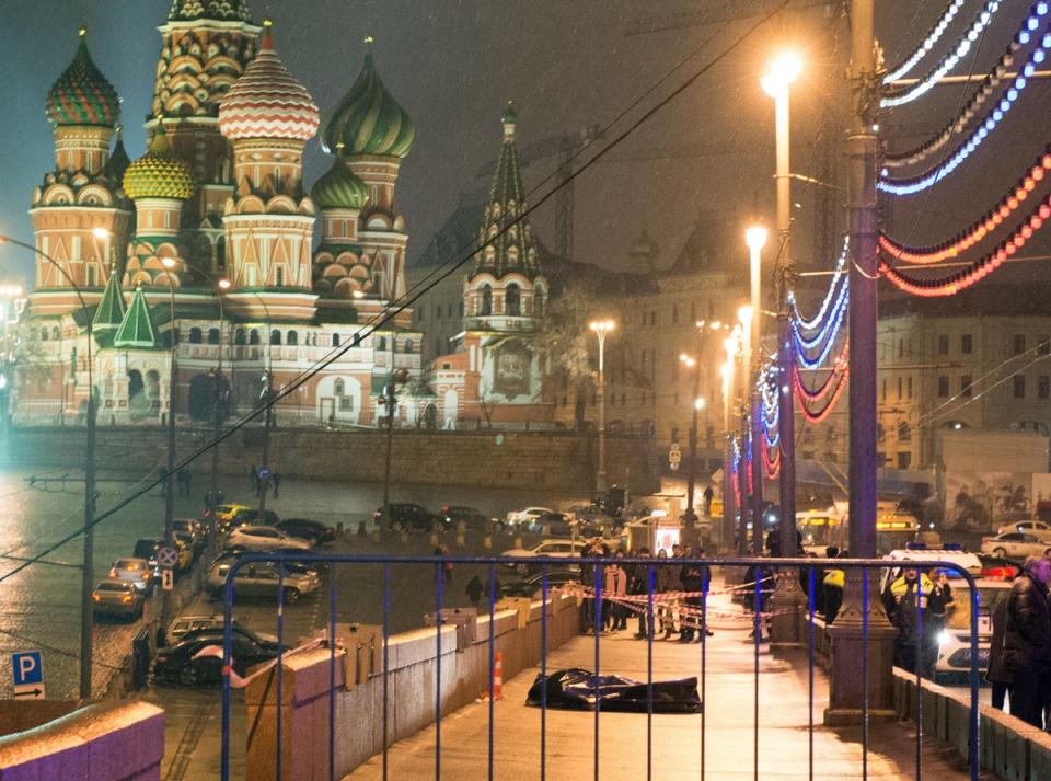 The body of Russian opposition leader Boris Nemtsov was covered with plastic after he was shot four times in the back on the Moskvoretsky bridge near the St Basil Cathedral in central Moscow on February 28, 2015 (AFP via Getty Images)