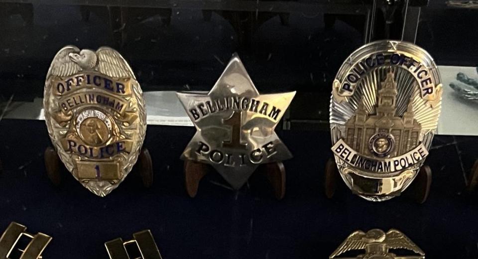 The Bellingham Police Department’s old badge, left, and its new badge, right, flank its first badge, a six-pointed star issued in 1904. The badges are in a display case with other badges and police memorabilia at the Bellingham Police Station in downtown Bellingham.