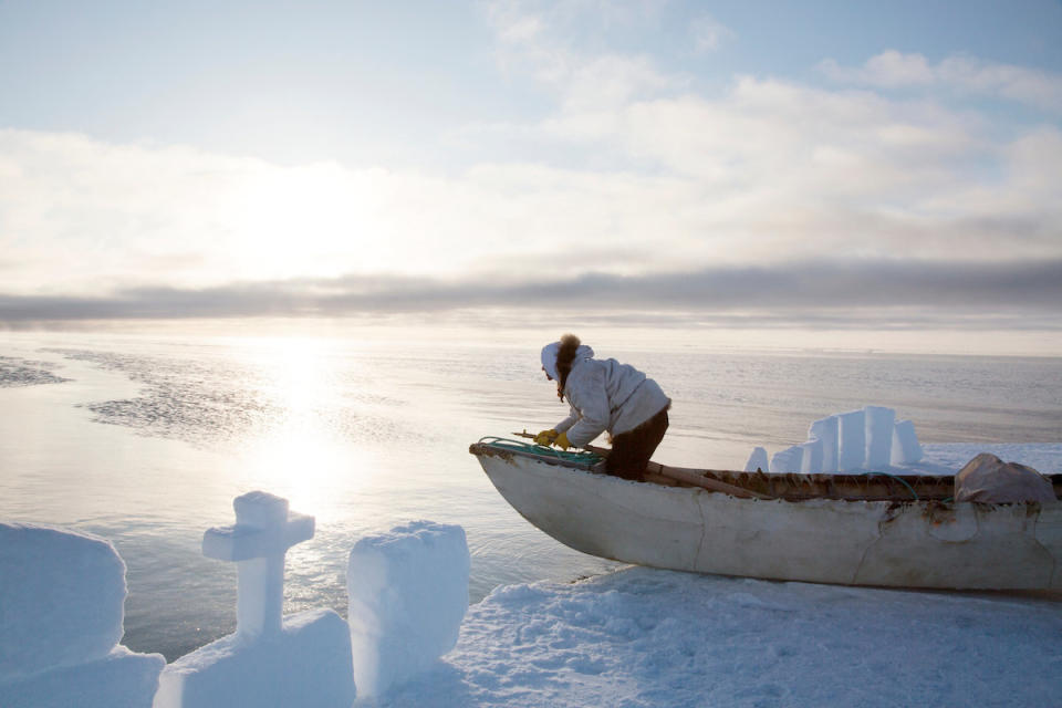 I&ntilde;upiat harpooner Quincy Adams surveys the horizon in a sealskin canoe for bowhead whales, miles from the Alaskan town of Barrow, on April 18, 2016. The snow wall was built by the whaling crew to conceal the camp from their prey. Shifting sea ice has made whaling increasingly dangerous, and many native villages have begun to experience food shortages.&nbsp;
