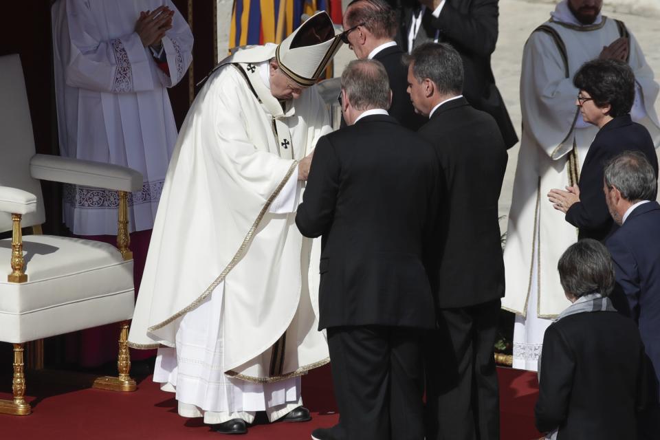 Pope Francis meets Jose Mauricio Moreira, of Salvador, center right, whose healing from glaucoma was considered a miracle that led to the canonization of Dulce Lopes Pontes, in St. Peter's Square at the Vatican, Sunday, Oct. 13, 2019. Francis presided over Mass on Sunday in a packed St. Peter's Square to declare Cardinal John Henry Newman and four women saints. (AP Photo/Alessandra Tarantino)