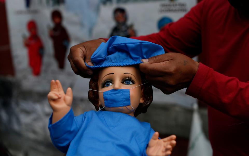 A baby Jesus figurine available for sale in Mexico City ahead of celebrations of Candlemas Day. Vendors said that some customers want a way to give thanks for family members having overcome the virus. - AP