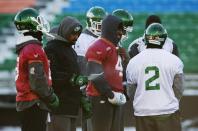 Saskatchewan Roughriders quarterback Darian Durant (4) stands with his teammates during practice in Regina, Saskatchewan, November 22, 2013. The Saskatchewan Roughriders will play against the Hamilton Tiger-Cats in the CFL's 101st Grey Cup in Regina. REUTERS/Mark Blinch (CANADA - Tags: SPORT FOOTBALL)