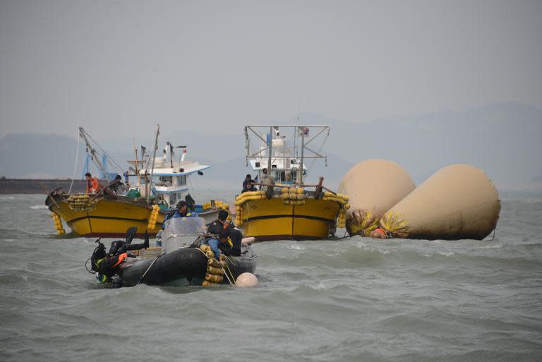A diver enters the water at the site of the submerged 'Sewol' ferry off the coast of Jindo, South Korea on April 21, 2014