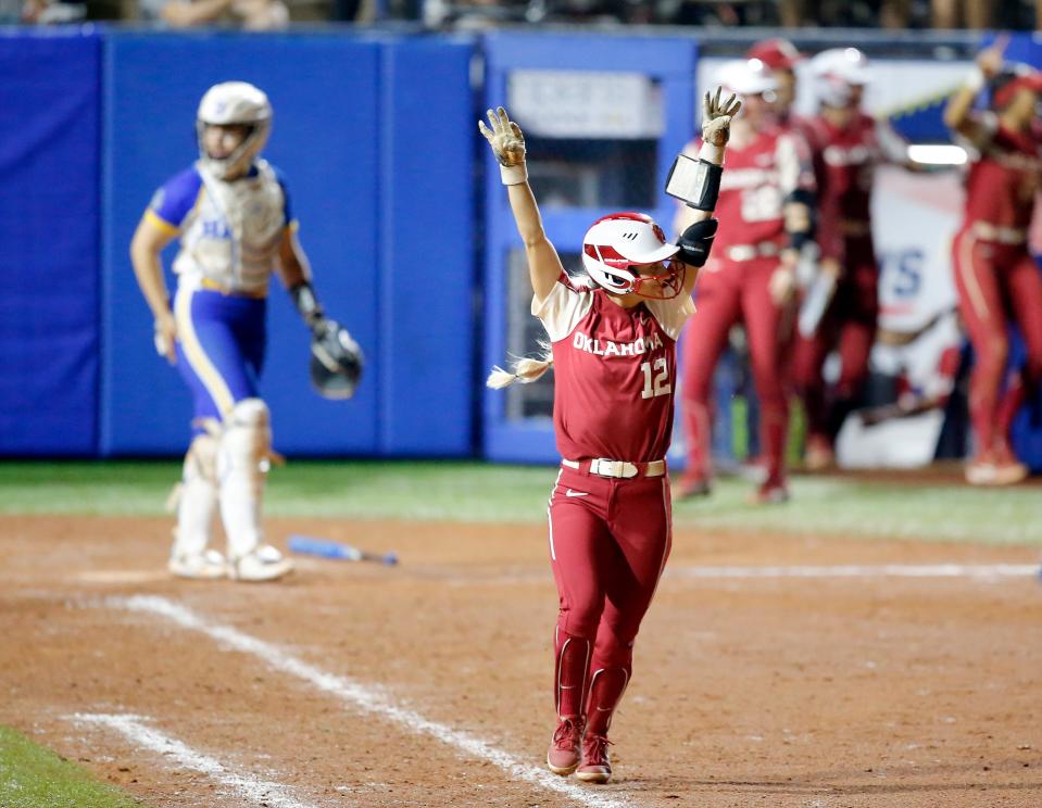 Oklahoma's Mackenzie Donihoo (12) celebrates a home run in the sixth inning of a Women's College World Series softball game between Oklahoma and UCLA at the USA Softball Hall of Fame Stadium in Oklahoma City, Saturday, June 5, 2021.