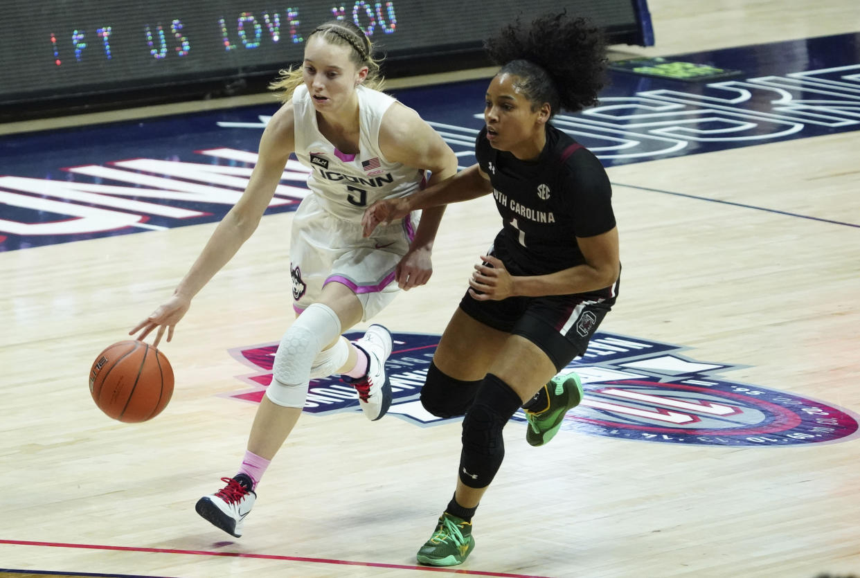 Connecticut guard Paige Bueckers (5) drives the ball against South Carolina guard Zia Cooke (1) in the first half of an NCAA college basketball game in Storrs, Conn., Monday, Feb. 8, 2021. (David Butler/Pool Photo via AP)