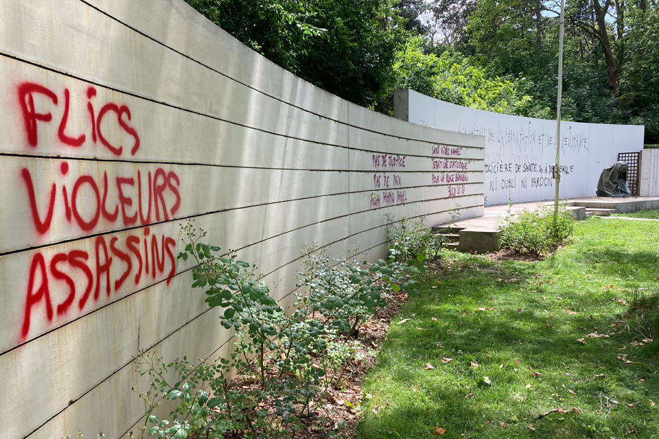 A graffiti reading "Police, rapists, assassins" on a monument commemorating Holocaust victims and members of the French resistance memorial, Sunday, July 2, 2023 in Paris suburb Nanterre. In Nanterre, a monument commemorating Holocaust victims and members of the French resistance during World War II was defaced with graffiti Sunday, after it has been vandalized Thursday on the margins of a silent march to pay tribute after the police killing of a teenager. (AP Photo/Cara Anna )