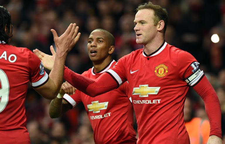 Manchester United's Wayne Rooney (R) celebrates scoring a goal with his teammates, during their English Premier League match against Sunderland, at Old Trafford in Manchester, north-west England, on February 28, 2015