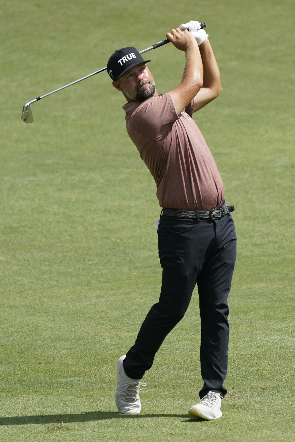 Ryan Moore watches his shot to the ninth hole during the third round of the Wyndham Championship golf tournament in Greensboro, N.C., Saturday, Aug. 6, 2022. (AP Photo/Chuck Burton)