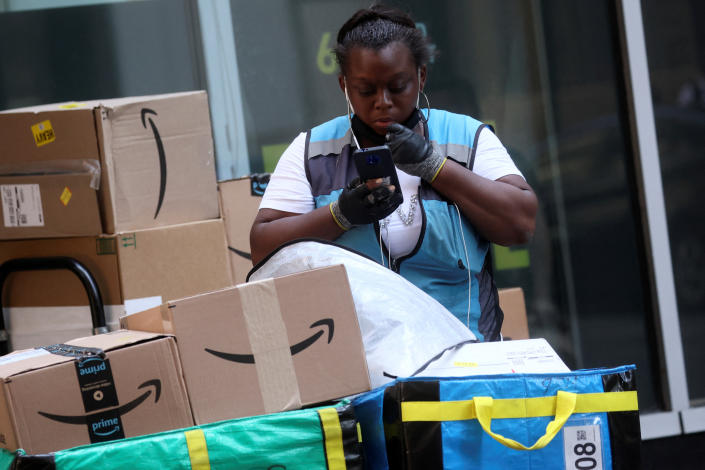An Amazon delivery worker checks packages in New York City, U.S., July 11, 2022.  REUTERS/Brendan McDermid