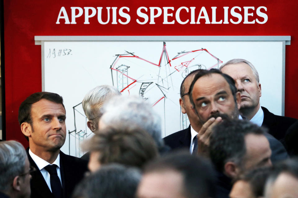 French Prime Minister Edouard Philippe, right, and French President Emmanuel Macron, left, watch the fire at Notre Dame cathedral in Paris, Monday, April 15, 2019. A catastrophic fire engulfed the upper reaches of Paris' soaring Notre Dame Cathedral as it was undergoing renovations Monday, threatening one of the greatest architectural treasures of the Western world as tourists and Parisians looked on aghast from the streets below.(Philippe Wojazer/Pool via AP)