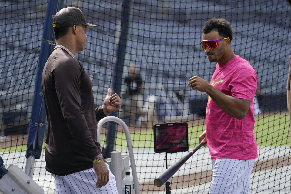 San Diego Padres right fielder Juan Soto, left, stands next to center fielder Trent Grisham during batting practice before team's baseball game against the Colorado Rockies on Wednesday, Aug. 3, 2022, in San Diego. (AP Photo/Gregory Bull)