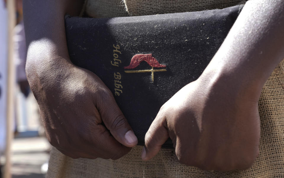 A member the United Methodist Church in Zimbabwe holds a bible while protesting at the church premises in Harare, Thursday, May 30, 2024. The protests denouncing homosexuality and the departure of the church from the scriptures and doctrine, come barely a month after the United Methodist Church Worldwide General Conference held in North Carolina, US repealed their church's longstanding ban on LGBTQ clergy, removing a rule forbidding "self-avowed practising homosexuals" from being ordained or appointed as ministers. (AP Photo/Tsvangirayi Mukwazhi)