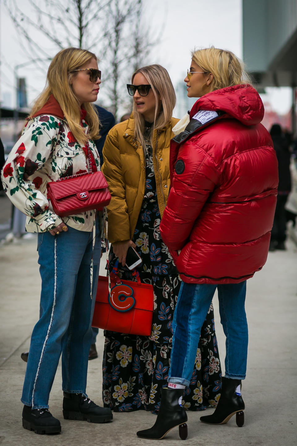 Annabel Rosendahl, Caroline Daur, and Charlotte Groeneveld are a striking trio in cherry-red at New York Fashion Week.