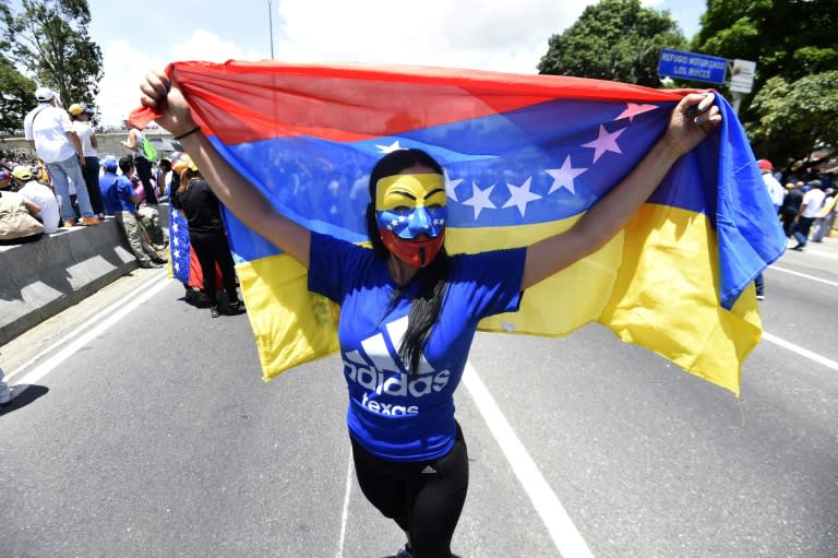 Opposition activists rally on Francisco Fajardo main motorway in eastern Caracas on May 20, 2017 to protest against President Nicolas Maduro