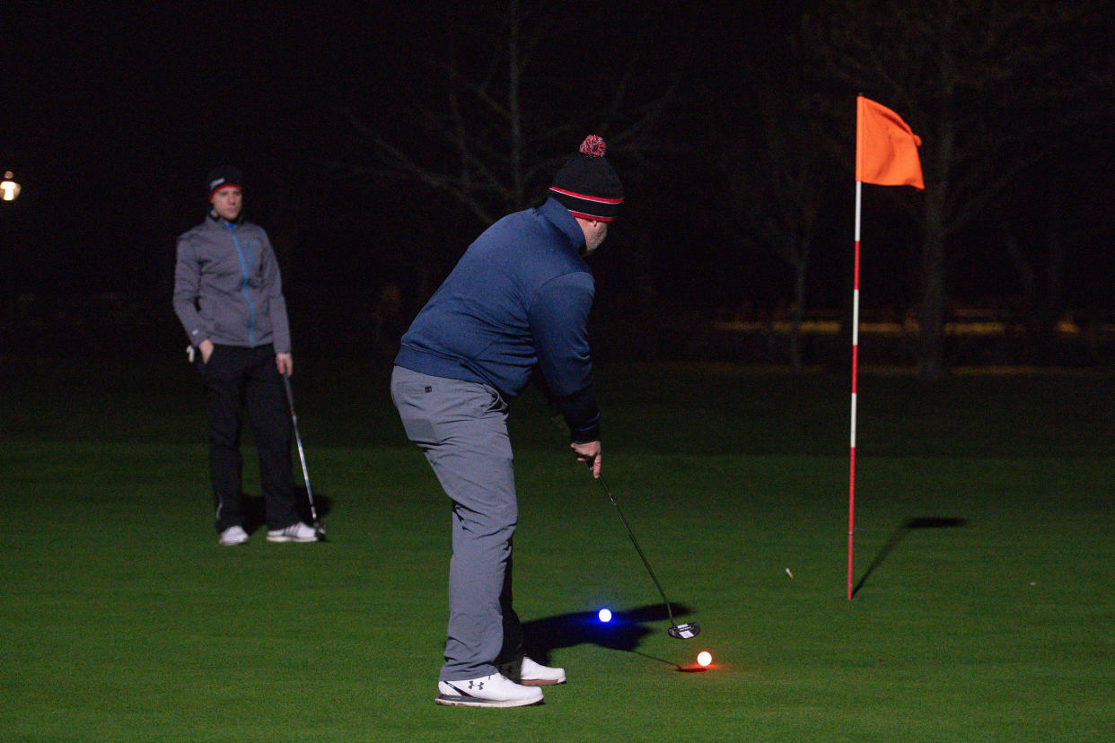 Golfers use neon coloured balls whilst under floodlights at Morley Hayes Golf centre in Ilkeston, Derbyshire. The club is believed to be the first to reopen, with the first tee times at 0001, following the easing of England's lockdown restrictions to allow greater freedom outdoors. Picture date: Monday March 29, 2021.