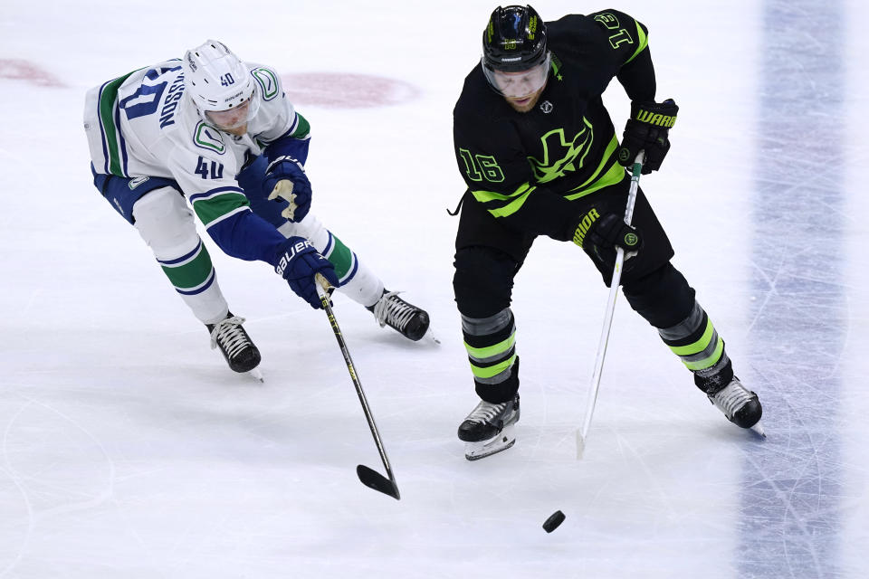 Vancouver Canucks center Elias Pettersson (40) defends against Dallas Stars center Joe Pavelski (16) during the third period of an NHL hockey game in Dallas, Saturday, March 25, 2023. (AP Photo/LM Otero)