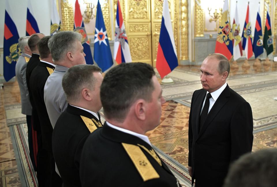 Russian President Vladimir Putin, right, greets top military officers and law enforcement officials in the Kremlin in Moscow, Russia, Thursday, Oct. 25, 2018. Putin said that Russia has adhered to its obligations in the arms control sphere, but noted that Russian arsenals will be modernized to ensure protection from any potential threats. (Alexei Nikolsky, Sputnik, Kremlin Pool Photo via AP)