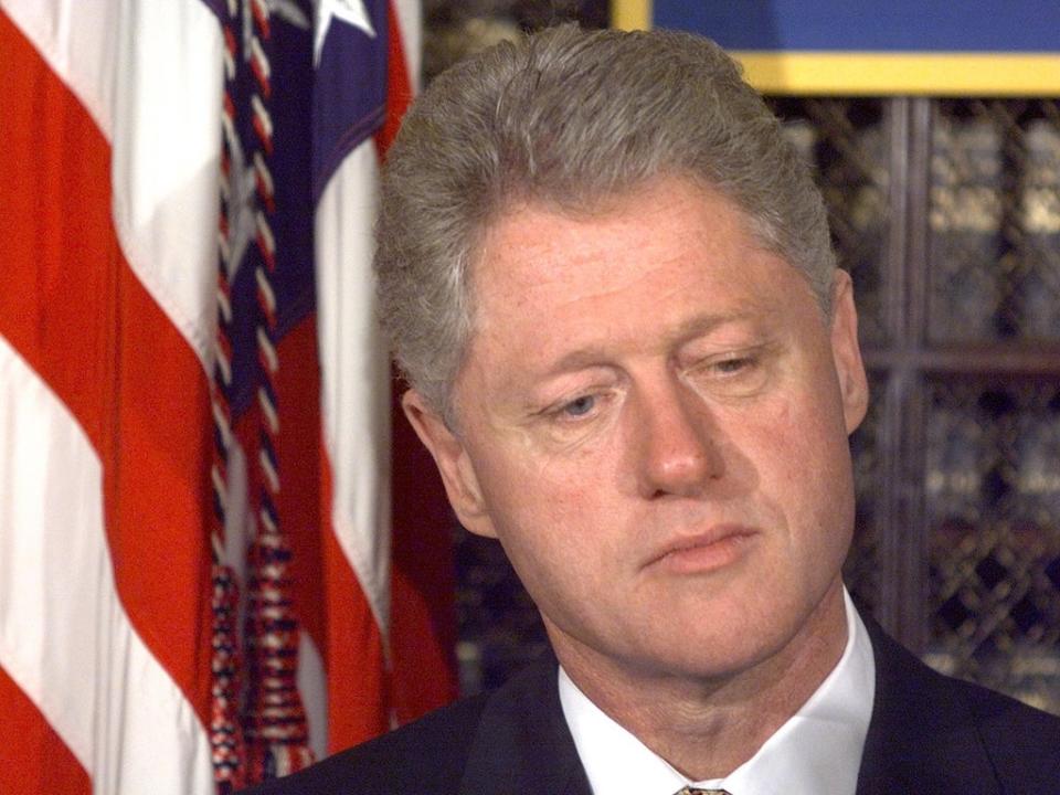 Bill Clinton in the Roosevelt Room of the White House as the House of Representatives conducts a full vote on whether to proceed with impeachment proceedings on 8 October 1998 (PAUL J RICHARDS/AFP via Getty Images)