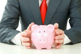 Young man with piggy bank (money box), isolated on white background