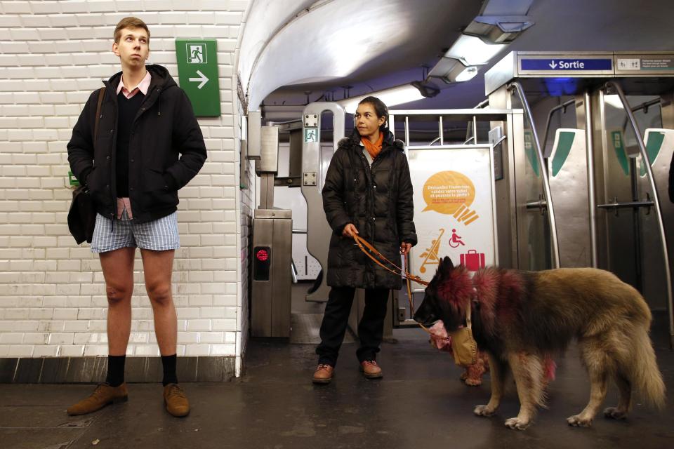 A passenger without his pants waits for a train during the "No Pants Subway Ride" event at a subway station in Paris