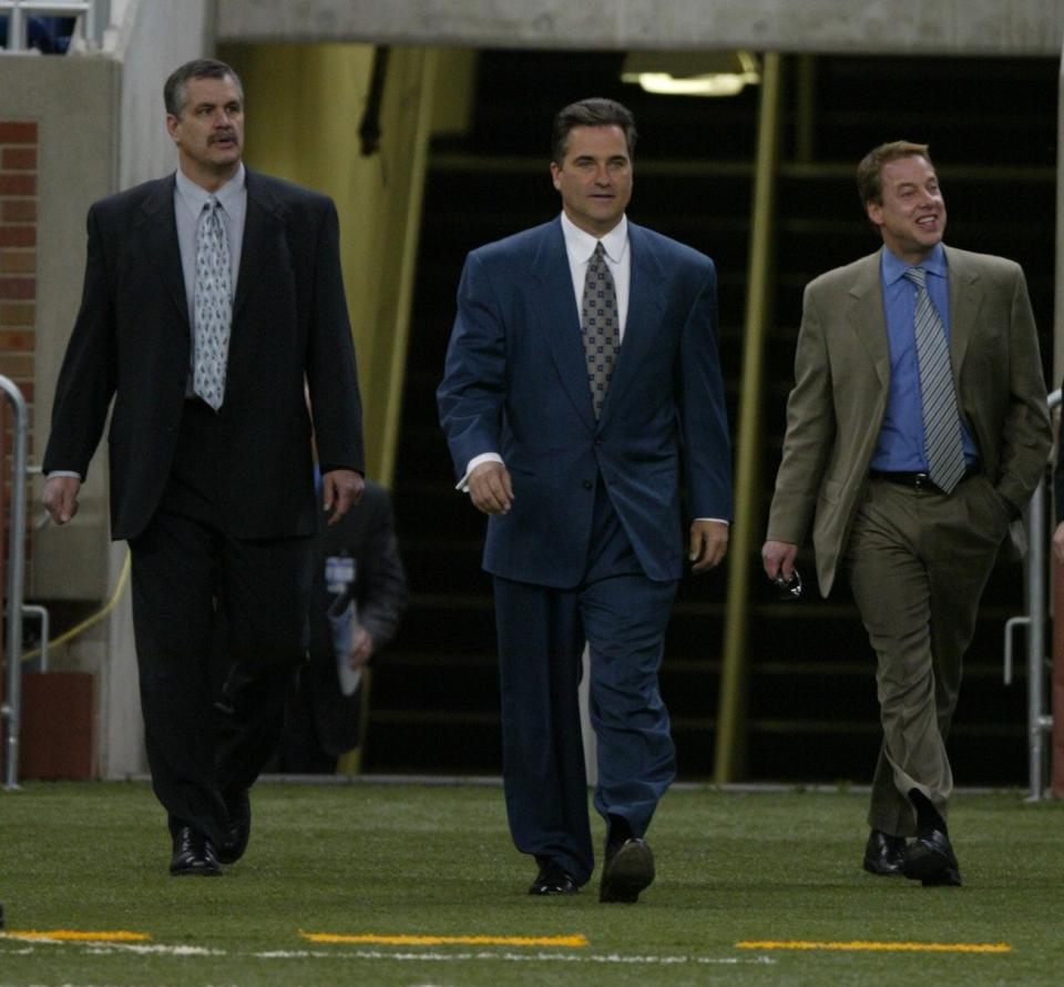 Lions president and CEO Matt Millen, left, walks on the field with Lions new head coach Steve Mariucci and William Clay Ford Jr., owner and vice chairman at Ford Field on Wednesday, Feb. 5, 2003.