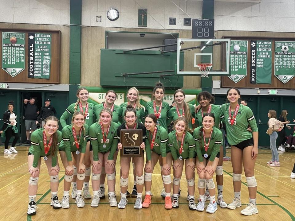 St. Mary's girls volleyball pose with its CIF girls volleyball NorCal Division 1 runner-up plaque.