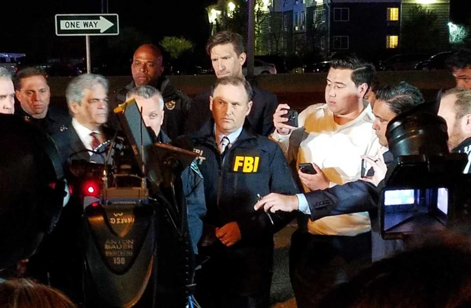 FBI Commander Christopher Combs, center, addresses reporters. / Credit: FBI