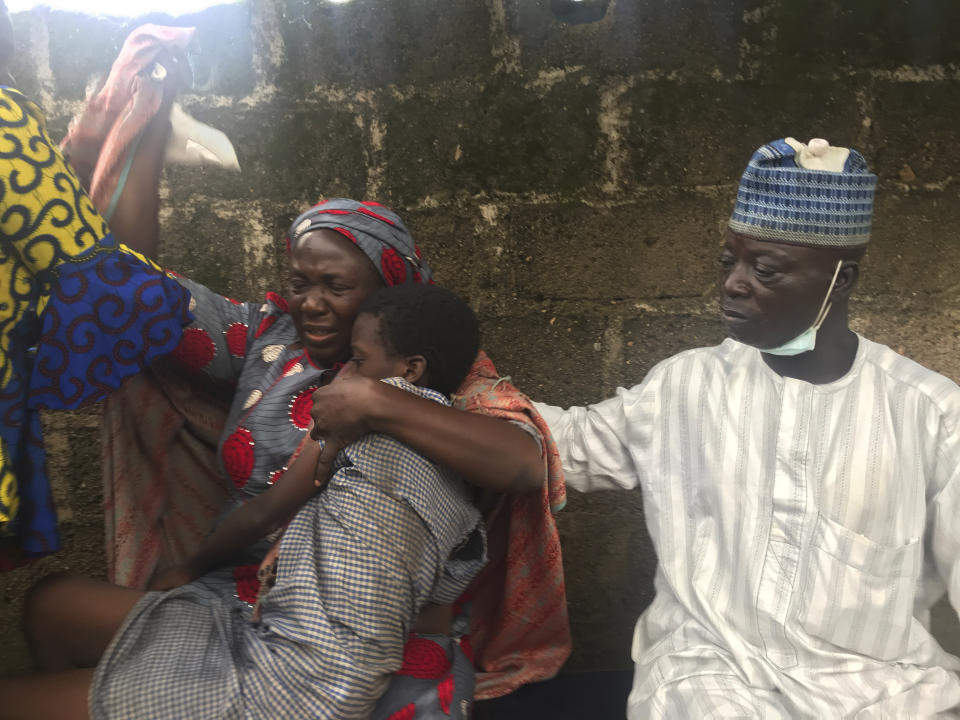 Parents are reunited with released students of the Bethel Baptist High School in Damishi, Nigeria, on Sunday, July 25, 2021. Armed kidnappers in Nigeria have released 28 of the more than 120 students who were abducted at the beginning of July from the Bethel Baptist High School in the northern town of Damishi. Church officials handed those children over to their parents at the school on Sunday. (AP Photo)