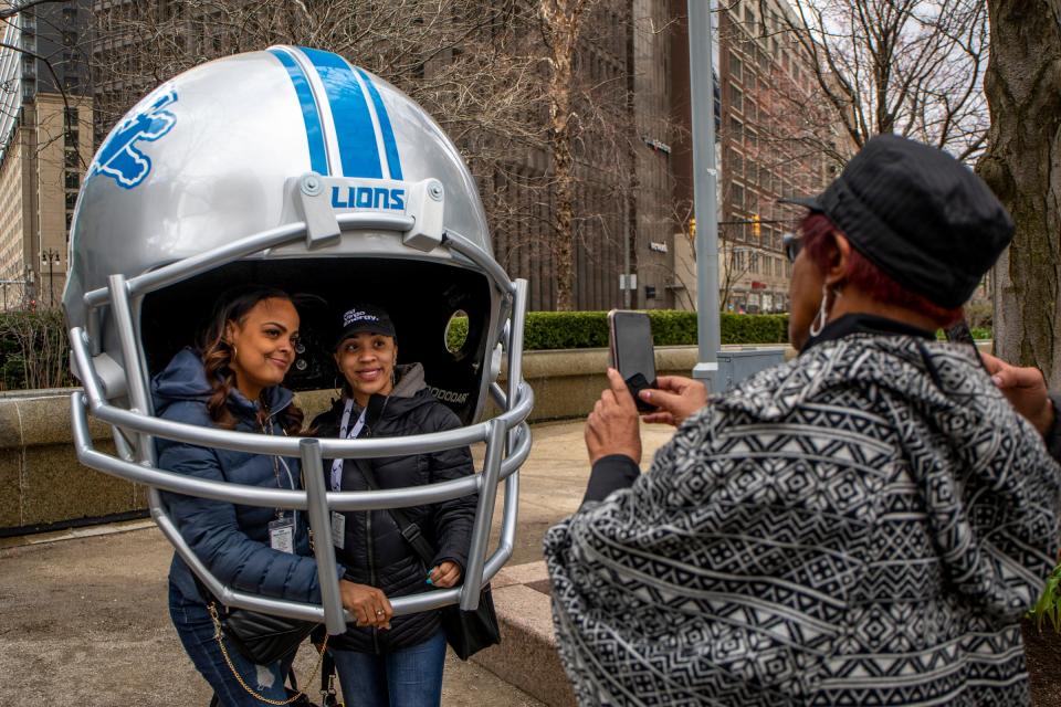 Latasha Storms, 41, left, and Landis Smith, 34, right, get their photo taken during the 2024 NFL Draft Celebration at Campus Martius Park in Detroit on April 14, 2022.