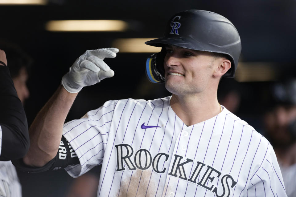 Colorado Rockies' Sam Hilliard is congratulated as he returns to the dugout after hitting a three-run home run off Kansas City Royals starting pitcher Carlos Hernandez during the third inning of a baseball game Saturday, May 14, 2022, in Denver. (AP Photo/David Zalubowski)