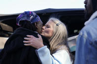 Jessie Blanchard, center, kisses and hugs a participant arriving to receive help with food, Naloxone, needled, tourniquets, condoms and other goods on Monday, Jan. 23, 2023, in Albany, Ga. (AP Photo/Brynn Anderson)