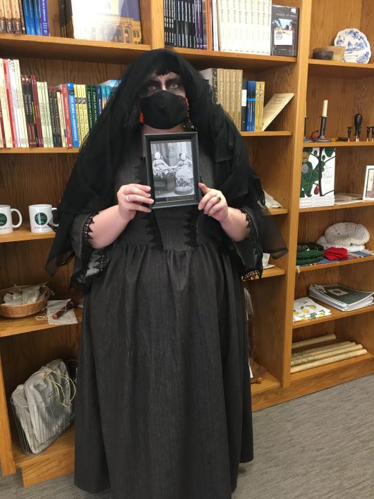 Stacey Olfe, a deputy clerk with the Knox County Criminal Court and a hobbyist in all things spooky, will lead tours in “Gone To Rest: Funeral Customs Through History.” Here, she displays a Victorian-era “death photo” of two siblings — only one of whom was alive at the time. Oct. 15, 2020.